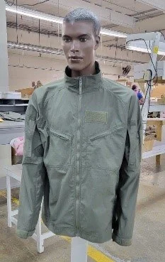 Sage-green military jacket on a mannequin on the Bethel Yuut production floor