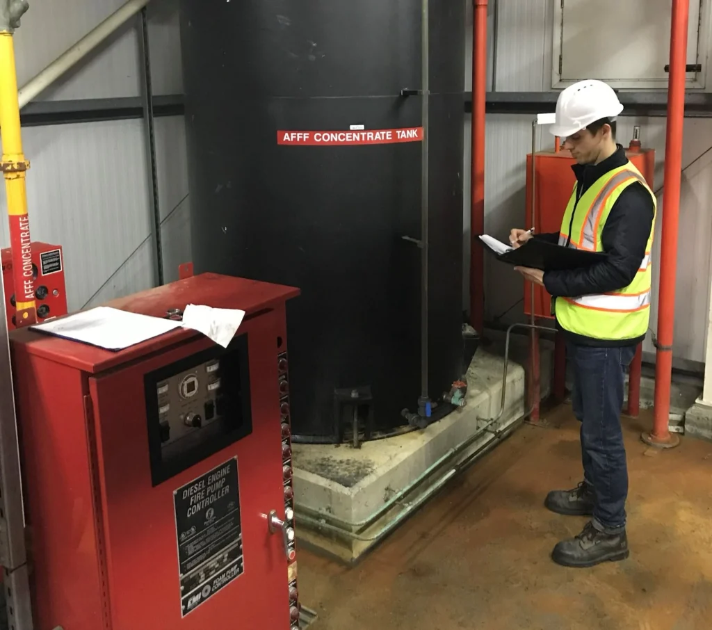 Inspecting fire suppressant tanks for refit, Ramstein Air Base, Germany, April 2018