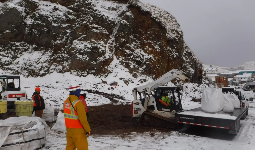 Loading bags of contaminated soil at the APIA site, Atka, Alaska
